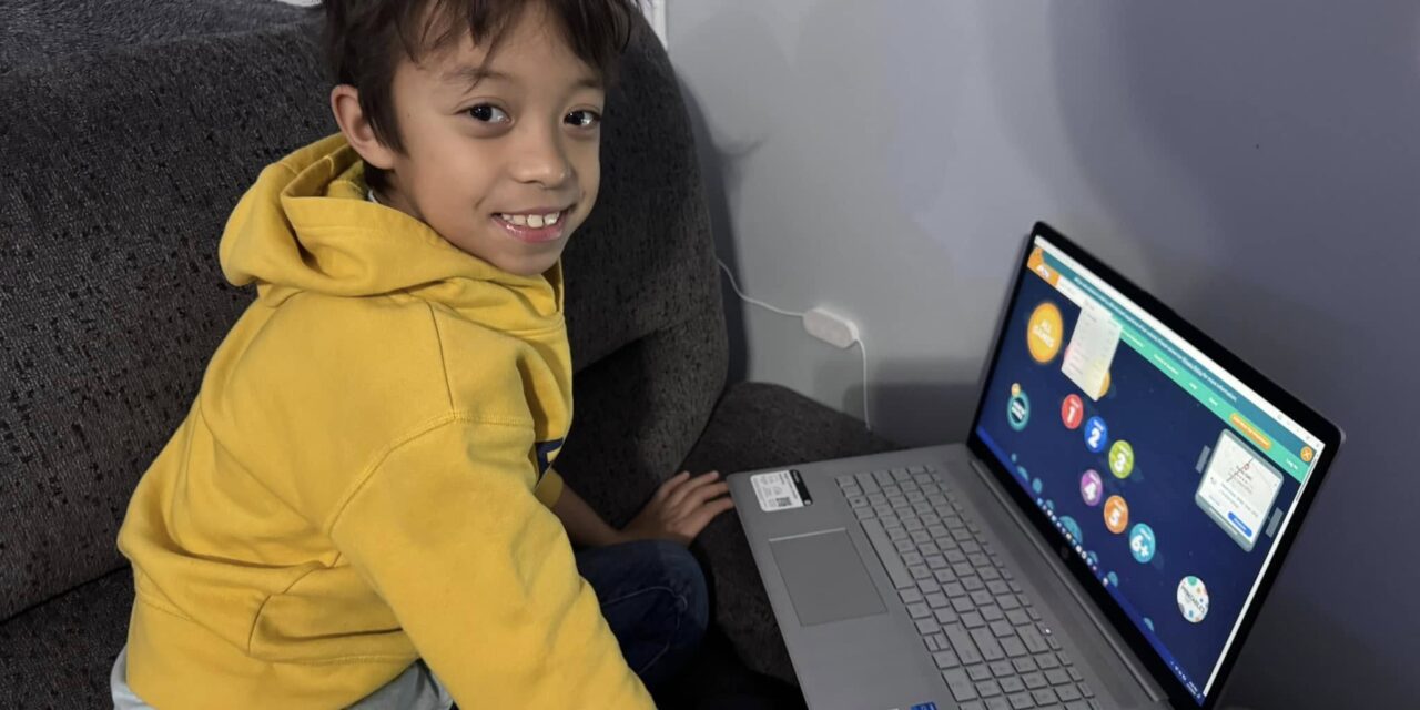 Xavier using laptop to help with his studies